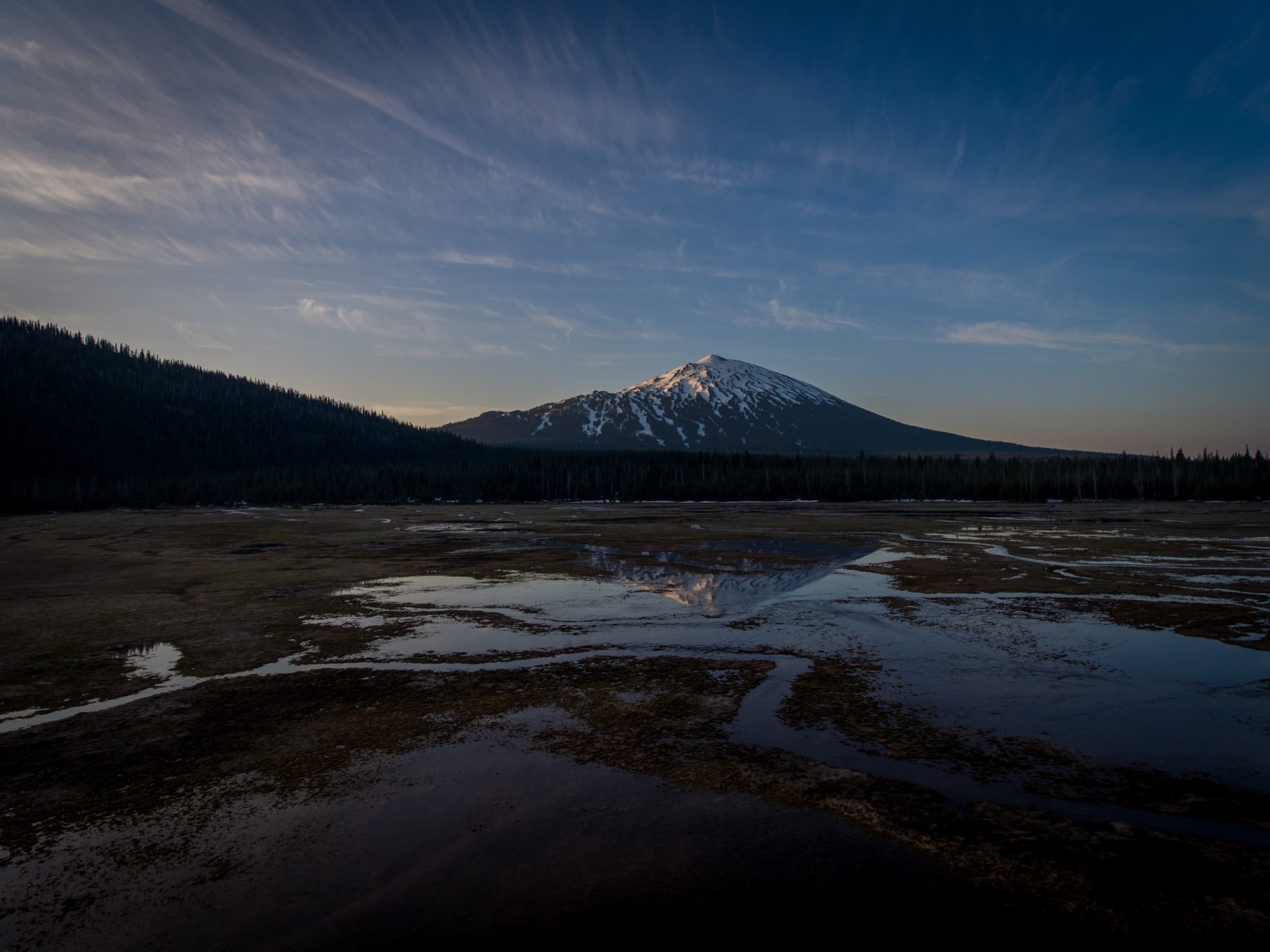 Sunrise at Cascade Lakes, igniting the sky with vibrant colors over tranquil waters.